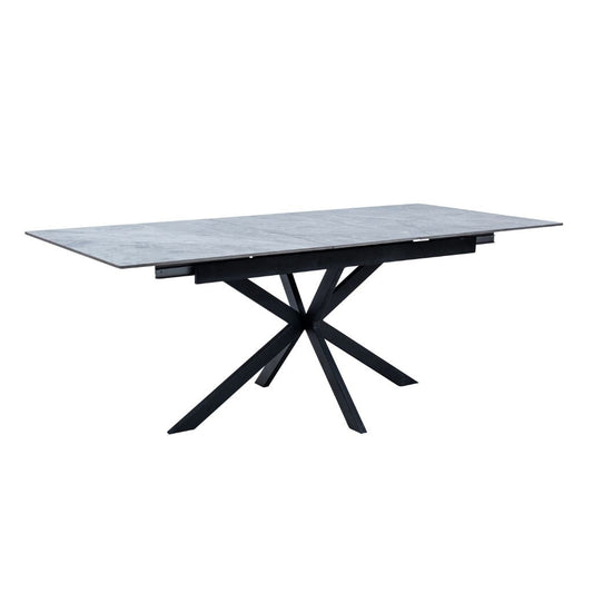 Modern dining table with marble top and black metal legs on a white background
