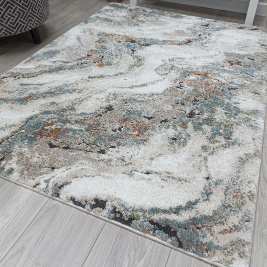Decorative area rug with a marble-like pattern on a wooden floor.