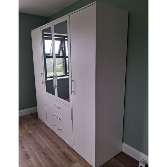 White wardrobe with glass panels against a green wall