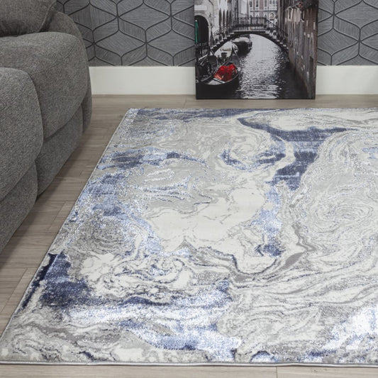 Marble-patterned rug on a wooden floor with a gray sofa and wall art in the background.