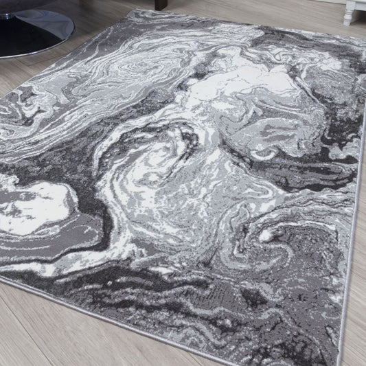 Gray and white marbled patterned rug on a wooden floor