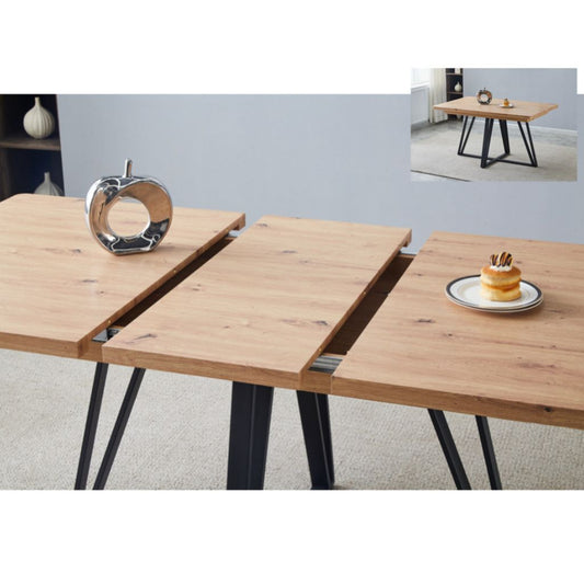 Wooden dining table with black metal legs, shown in a room setting.