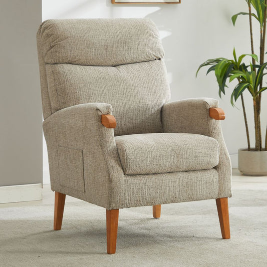 Beige armchair with wooden arms and legs in a room with a plant.