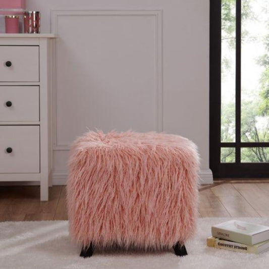 Pink fluffy ottoman in a room with a white dresser and a window.