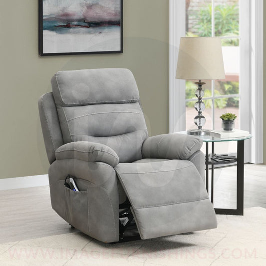Gray recliner chair in a living room setting with a lamp and table in the background.
