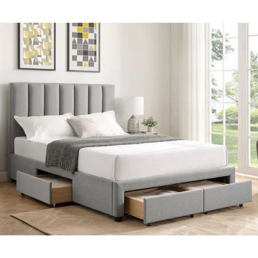 Grey upholstered bed with storage drawers in a room with large windows.