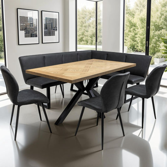Dining area with a wooden table and black chairs in a modern room with large windows.