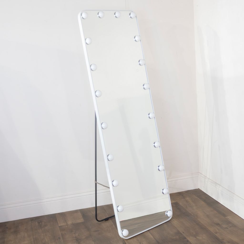 Floor mirror with light bulbs on a plain background