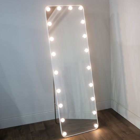 Rectangular mirror with lights on a wooden floor against a white wall