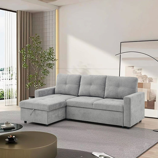 Grey sectional sofa bed in a modern living room with a plant and coffee table.