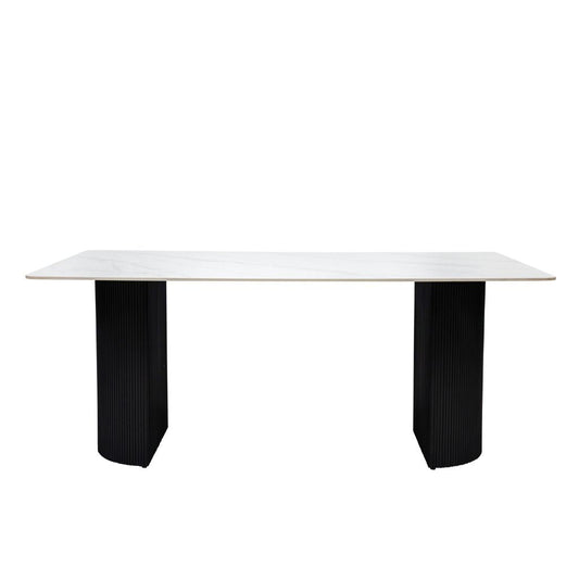White table with black ribbed legs on a white background