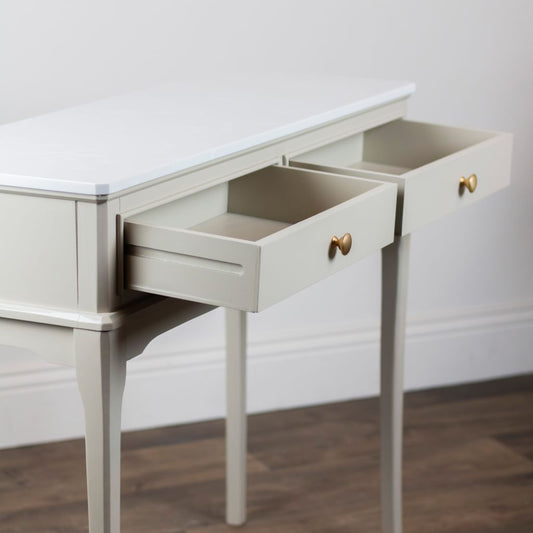 Stone console with open drawers against a white wall