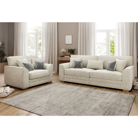 Beige sofa set with matching armchair in a living room setting.