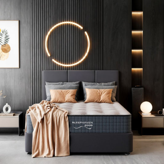 Gray mattress with 'Sleephaven' branding in a modern bedroom setting.