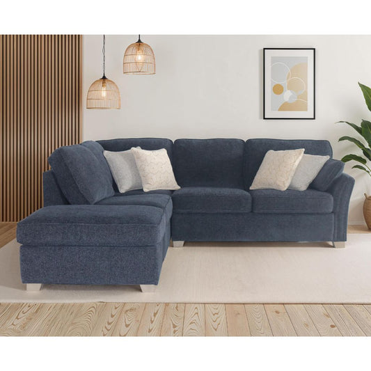 Blue sectional sofa in a living room setting with decor elements.
