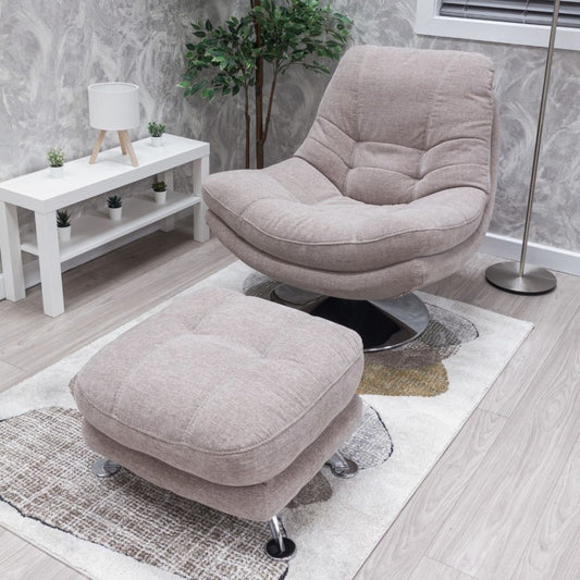 Beige armchair and ottoman set in a room with a white table and plant.