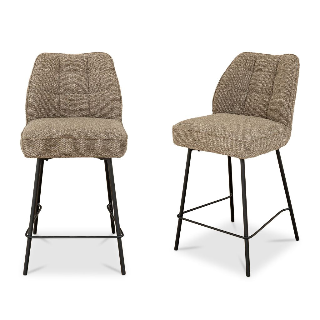Two brown bar stools with quilted seats on a white background