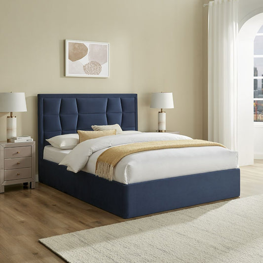 Modern bedroom with a blue upholstered bed, white bedding, and beige walls.
