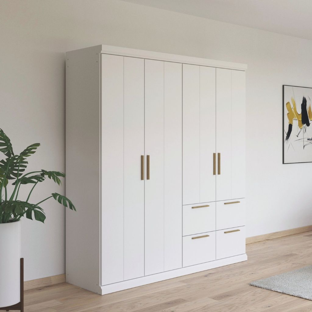 White wardrobe with oak handles in a room with a plant and abstract art on the wall.