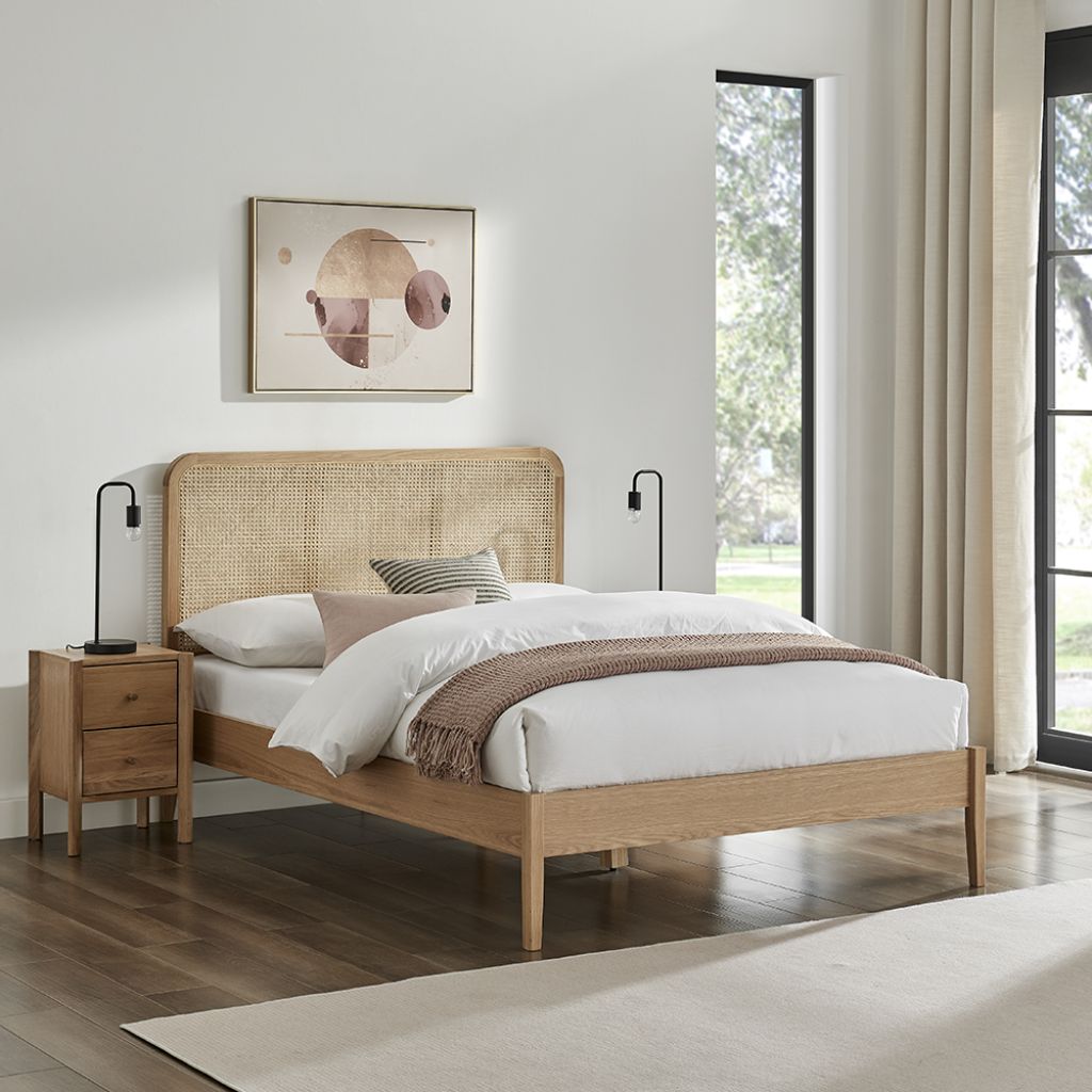 Bedroom with wooden bed, nightstands, and abstract art on the wall.