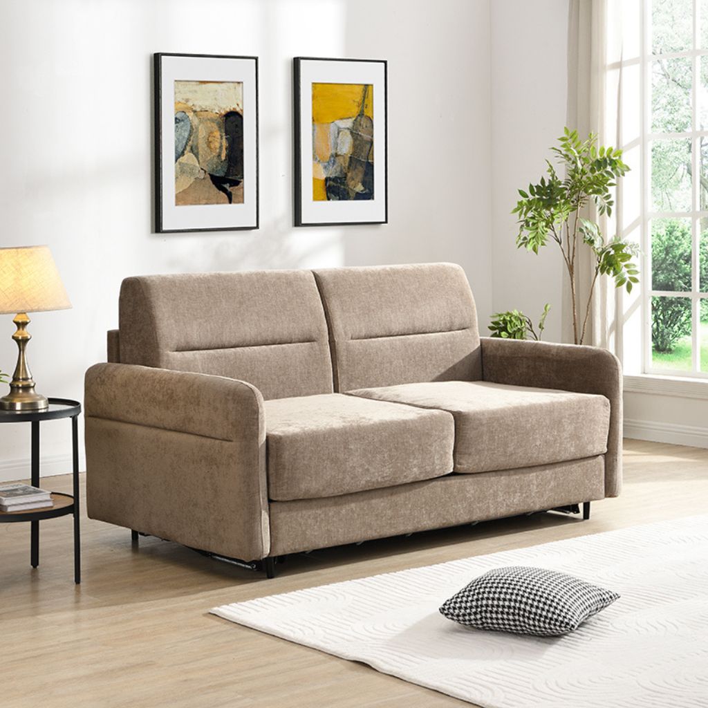 Beige sofa in a living room with abstract art on the wall and a lamp.