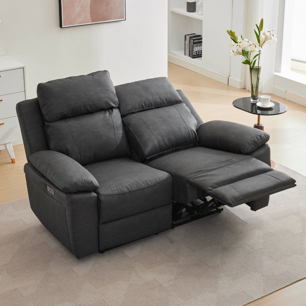 A dark grey two-seater electric recliner sofa with both cushions and the footrest extended.