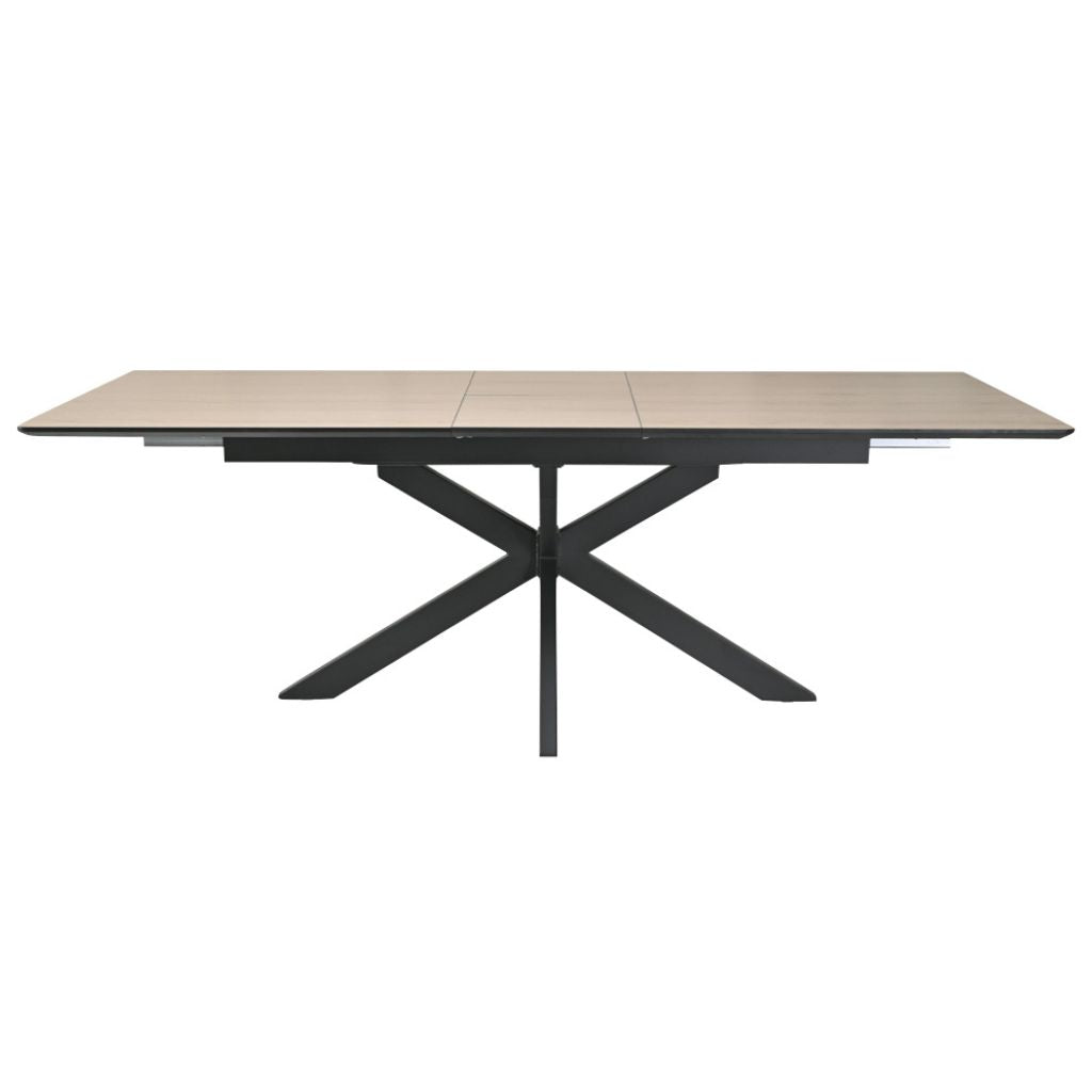 Oak dining table with black metal legs on a white background