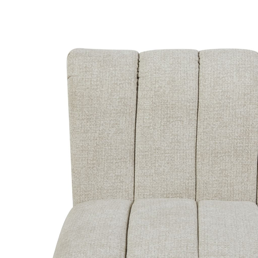 Close-up of fabric upholstered chair or sofa section with vertical channel stitching in colour oatmeal