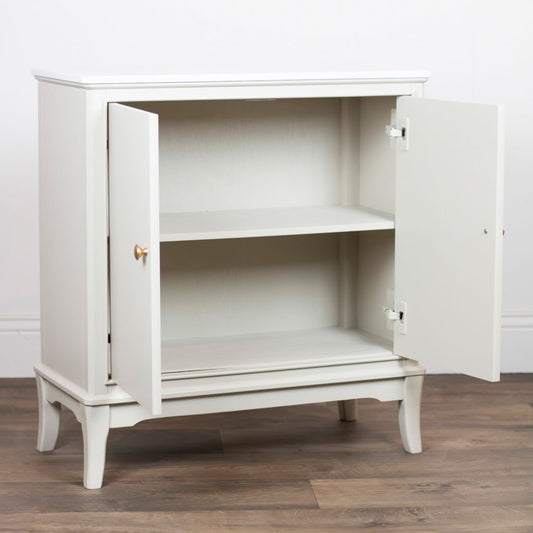 Stone cabinet with open doors on a wooden floor against a white wall