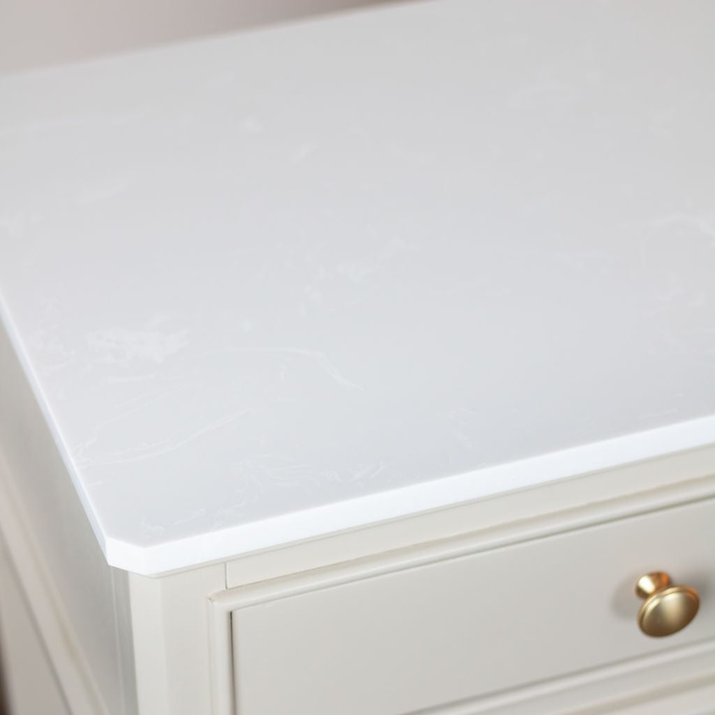 White countertop with a gold handle on a neutral background