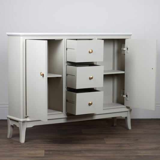 Stone cabinet with open doors and drawers on a wooden floor.