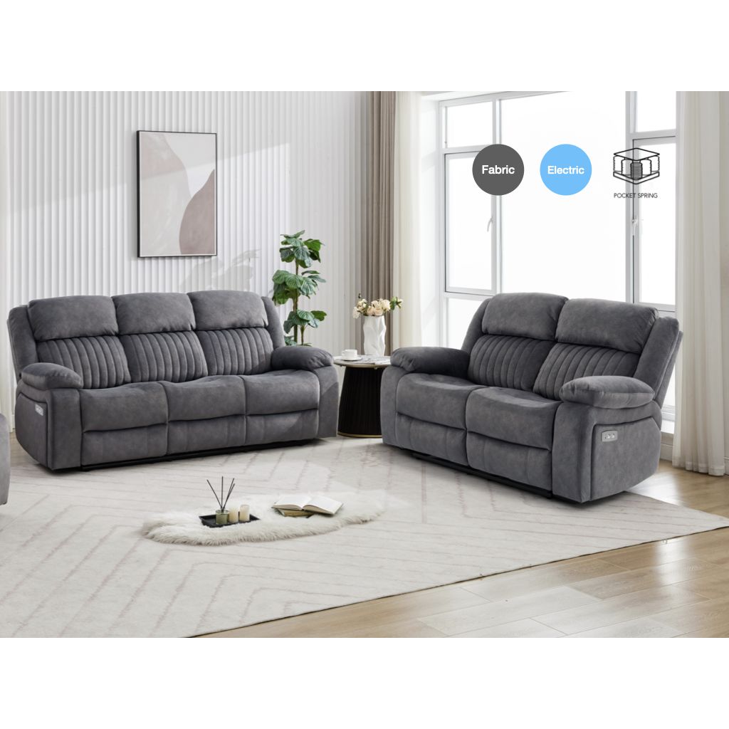 Gray sofa set in a living room with a rug and small table.