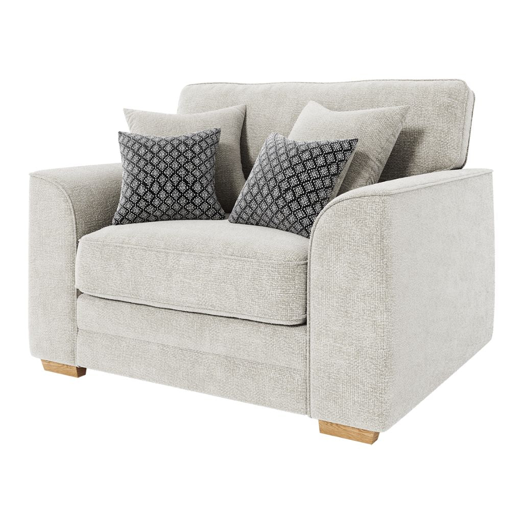 Beige sofa with patterned cushions on a white background