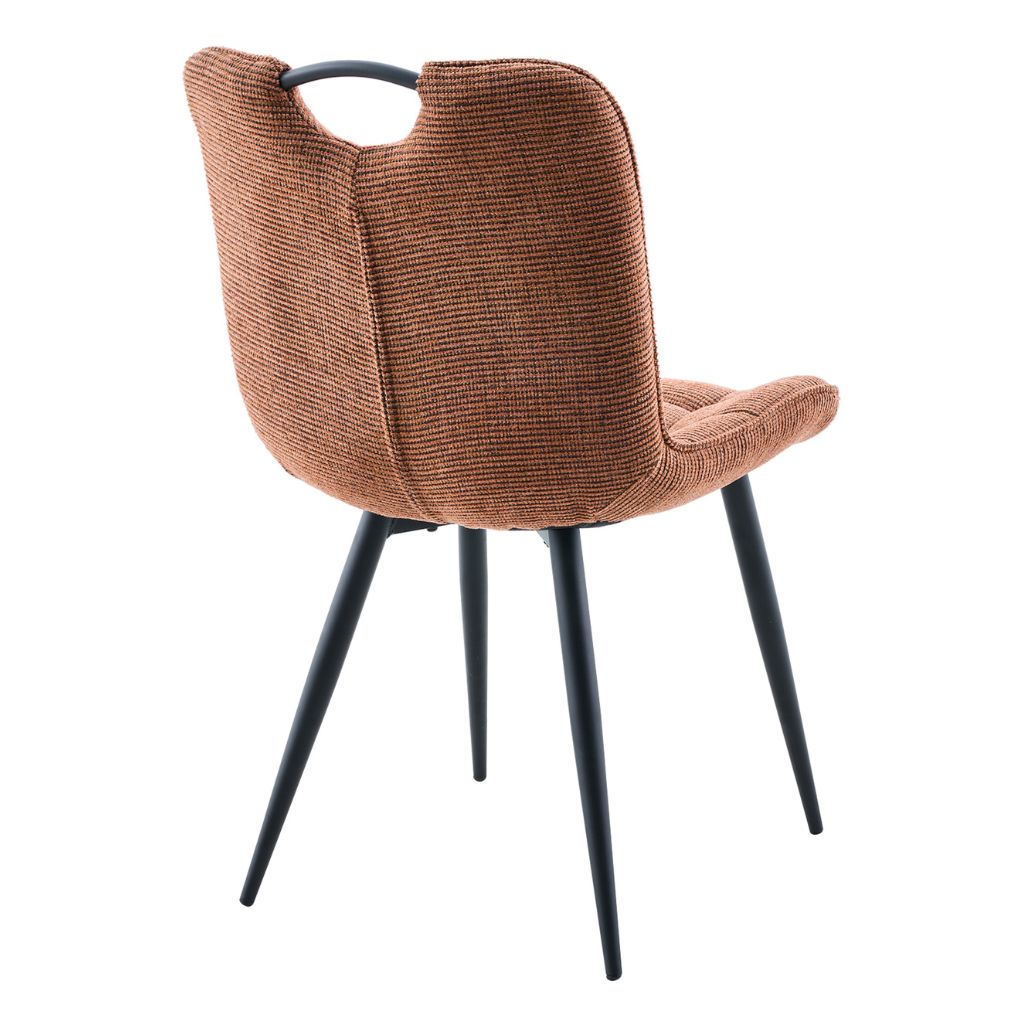 Rust upholstered chair with black legs on a white background