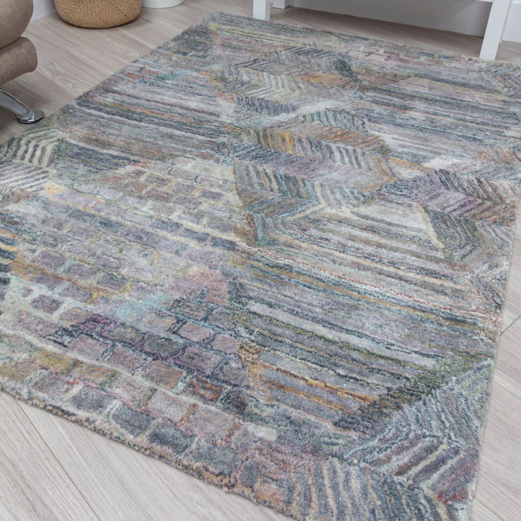 Multicolored patterned rug on a wooden floor