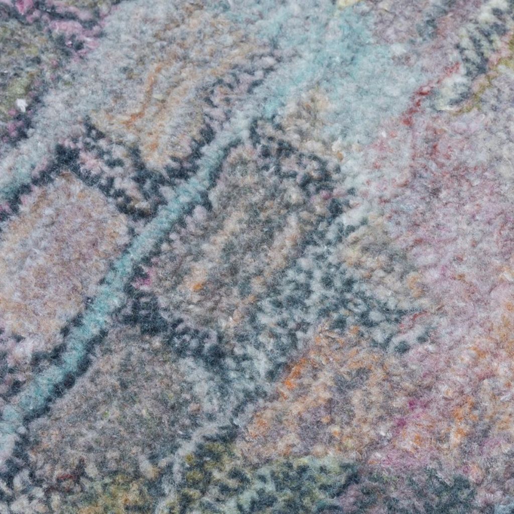 Close-up of a textured, multicolored fabric with a geometric pattern