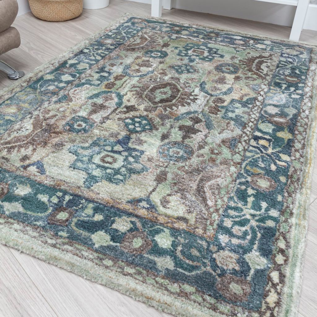 Decorative rug with intricate patterns on a light wooden floor.