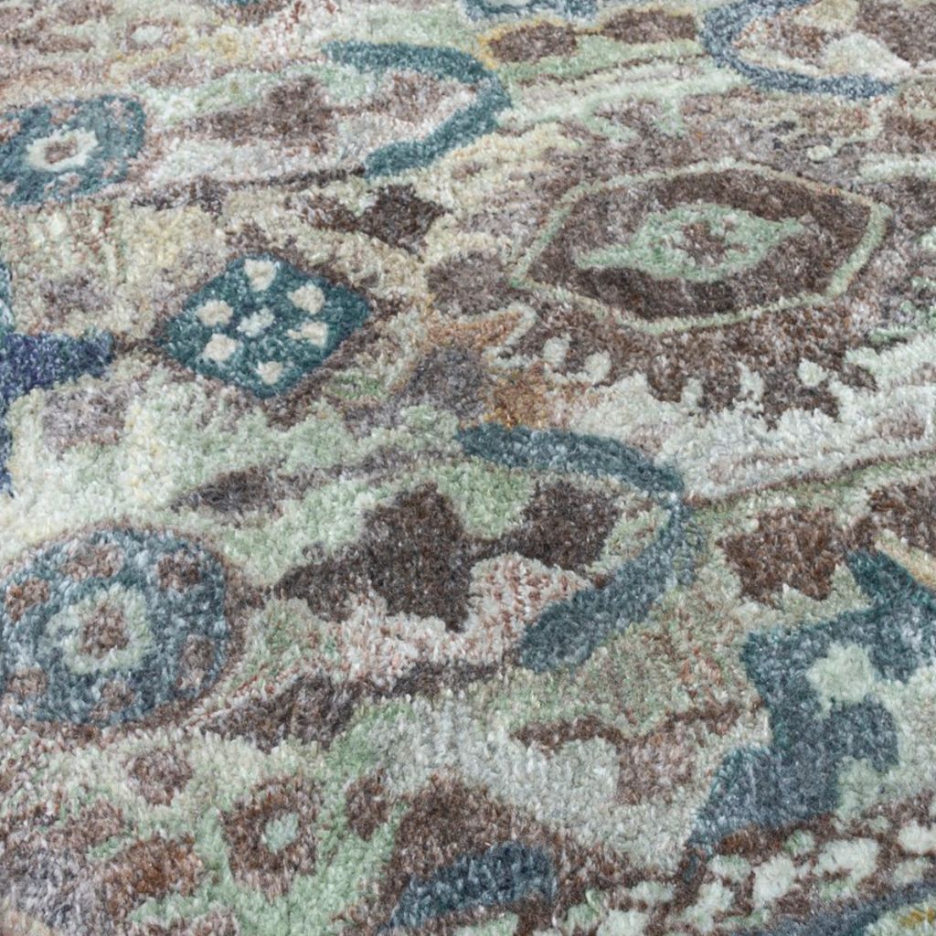 Close-up of a patterned rug with intricate designs in various colors.