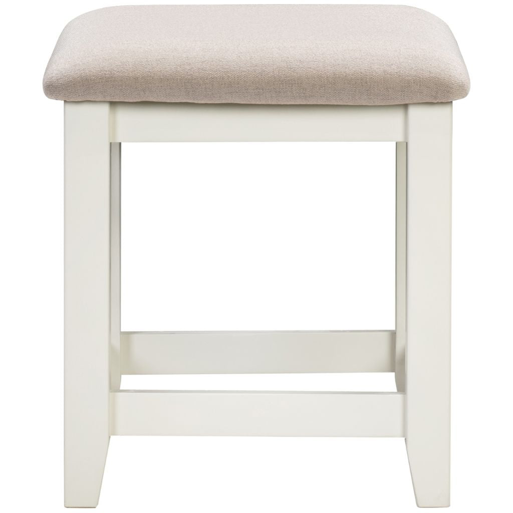 Ivory stool with a beige cushioned seat on a white background